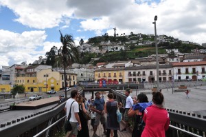 Group of tourists in the Center of Quito with the Panecillo in the back